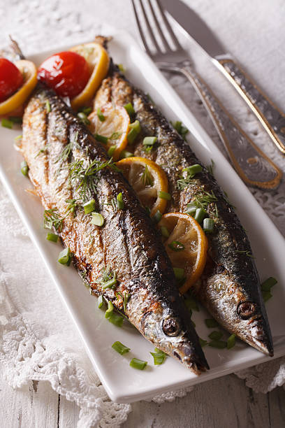 istock Beautiful food: grilled fish with lemon on plate close-up 614627428