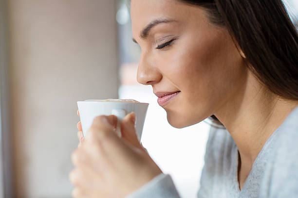 beautiful woman sipping her coffee - espresso women cup drink imagens e fotografias de stock