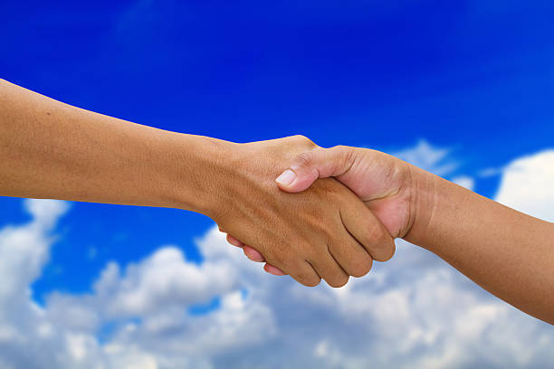 istock handshake in a business  shaking hand on beautiful cloud 614628940