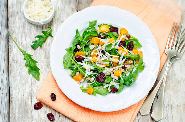 istock pumpkin arugula salad barley dried cranberries 614629176