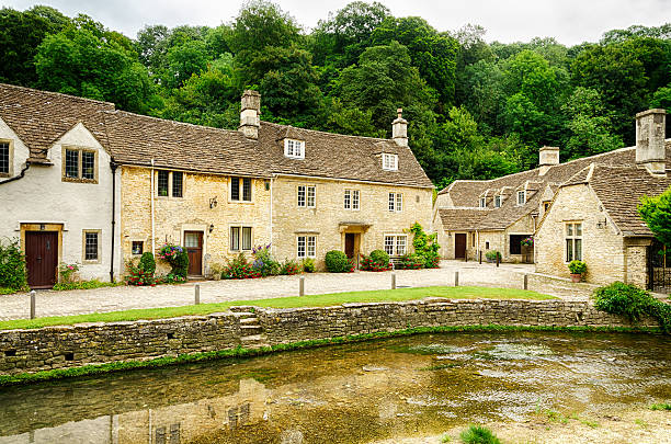 istock Waterway through Castle Combe Village in Wiltshire, England 614631840