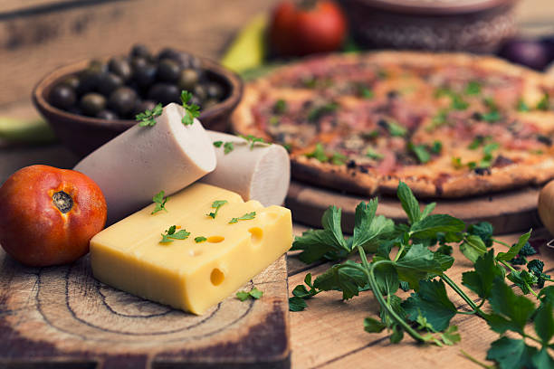 Rustic Pizza on Wooden Table with Food Ingredients