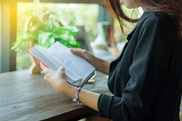 istock Asian woman reading a book for relaxation 614633394
