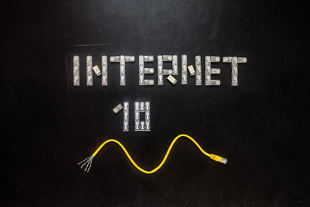 Word "Internet" and numeral "10", made of connectors RJ45 Word "Internet" and numeral "10", made of connectors RJ45 and yellow patch cord isolated over the black scratched board background. computer plan fiber optic engineer stock pictures, royalty-free photos & images