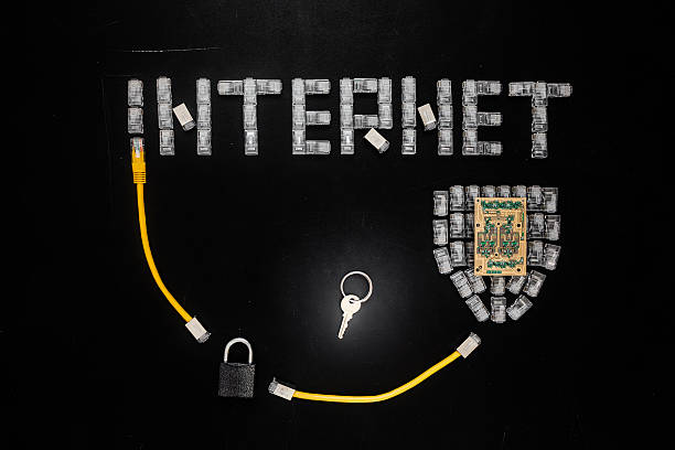 Word "Internet", shield made of connectors RJ45, padlock and key, Word "Internet", shield made of connectors RJ45, padlock and key, yellow patch cords composition isolated over the black scratched board background. Concept of internet security/computer data encryption / data protection / security enhancement / internet communication. computer plan fiber optic engineer stock pictures, royalty-free photos & images