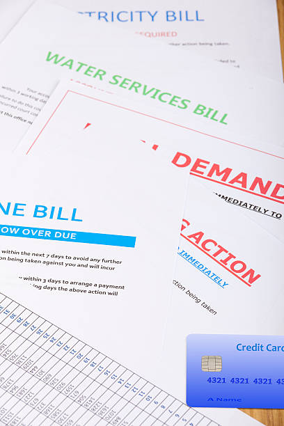 istock Bills and a credit card laying on a table 614639530