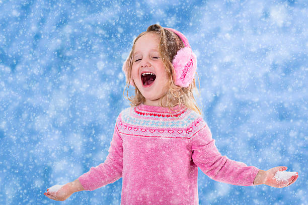 istock Little girl singing in snowy park 614645288