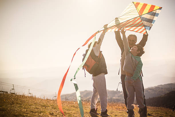 istock Flying a kite with Grandfather 614645536