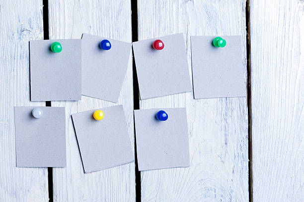 istock blank sheets of paper pinned colored buttons 614646284