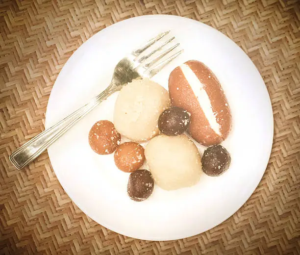 Popular Bangladeshi Sweetmeats in a plate with fork