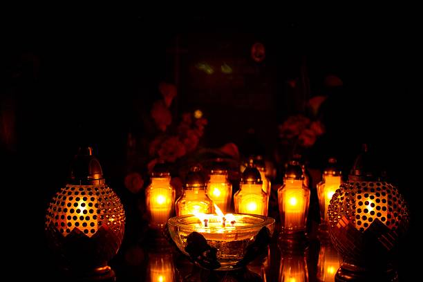 istock glowing candles on the grave 2 614704336