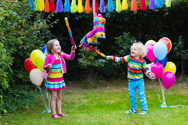 istock Kids playing with birthday pinata 614705254