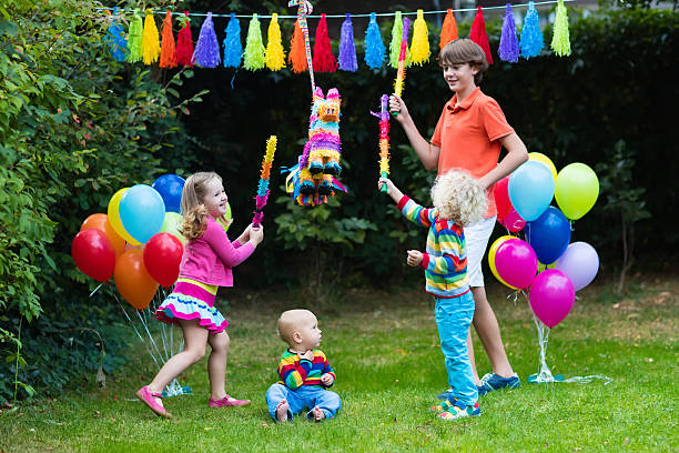 istock Kids siblings playing with birthday pinata 614706578