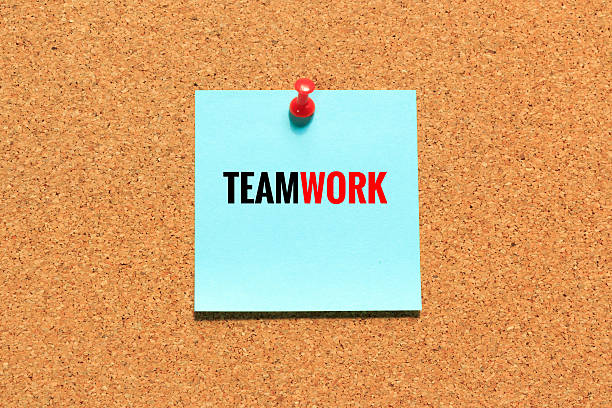 istock Cork board with team work wording on blue sticky notes 614706634