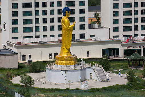 Ulan Bator, Mongolia - July 3, 2016: A statue of Buddha overlooks a residential area of Ulan Bator, at the foot of Zaisan Hill.