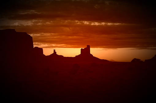 Retro image of monument valley buttes at sunset. 