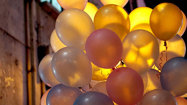 istock colourful in town party balloons at night with back light 614710328
