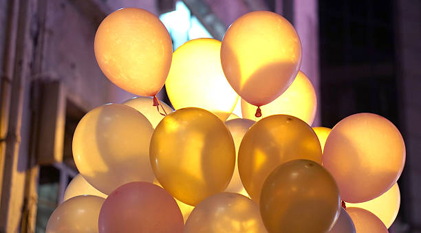 istock Colourful in town party balloons at night with back light 614710598