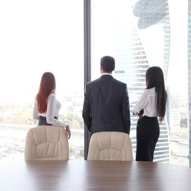 istock Business people looking at window 614712010