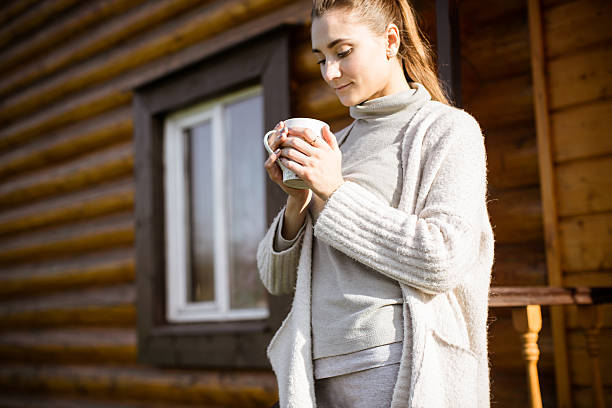 istock Girl drinks hot tea in autumn 614715056
