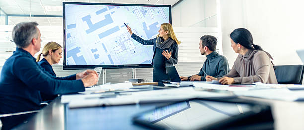 Pregnant female architect having a presentation