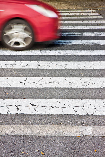 istock Black and white pedestrian crossing with car on background 614716606