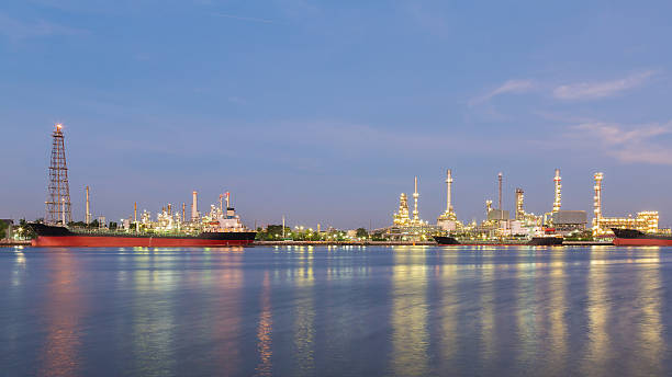 istock Panorama Oil refinery river front with blue sky background 614719264