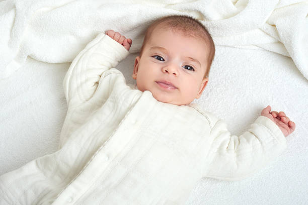 istock baby on white towel in bed 614719406