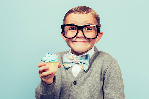 istock Young Nerd Boy Loves Eating Sweets 614719756