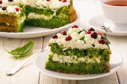 Spinach cake with cream and cranberries.