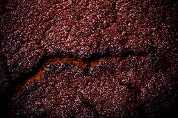 istock Top of fresh chocolate cake with cracks. Toned 614724108