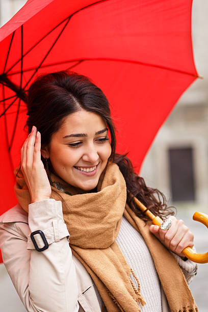 istock Woman with red umbrella 614724584