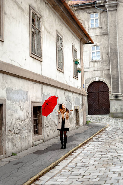 istock Woman with red umbrella 614725488