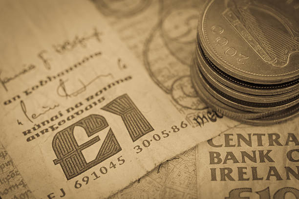 Bank notes and coins (Ireland) Vintage finish of image of bank notes and coins (Ireland) - currency in use until Ireland adopted the Euro.   irish punt note stock pictures, royalty-free photos & images