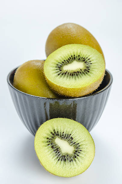 istock kiwi fruit and half with black bowl 614726374
