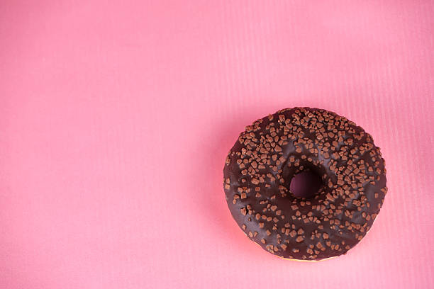 istock Sweet colorful tasty donuts on pink background. 614726452
