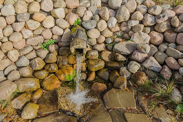 pure spring water closeup. stones, drinking useful. medical - well fountain water pipe pipe imagens e fotografias de stock