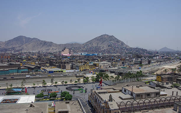 Slums on the slope of hill San Cristobal Lima, Peru - December 31, 2013: Slums on the slope of hill San Cristobal and downtown on the northern side of the river Rimac. View form roof of Convento de Santo Domingo poverty mexico environment slum stock pictures, royalty-free photos & images