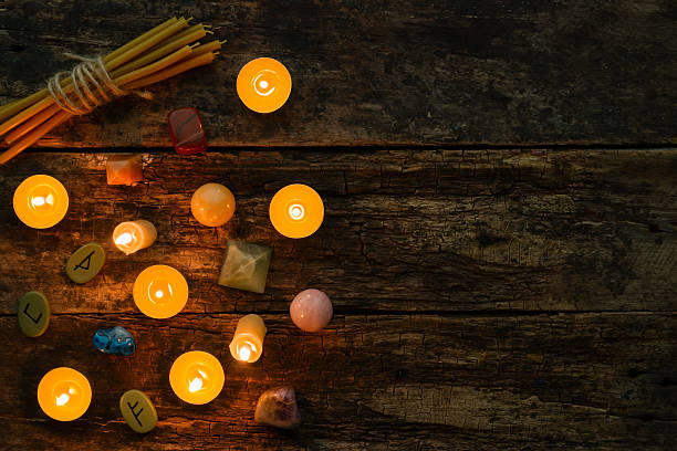 istock objects for divination, runes and candle on a wooden background 614728070