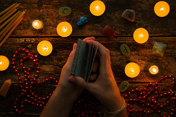 fortuneteller reads fortunes by tarot cards and candles fortuneteller reads fortunes by tarot cards and candles on the background of the runes runes photos stock pictures, royalty-free photos & images