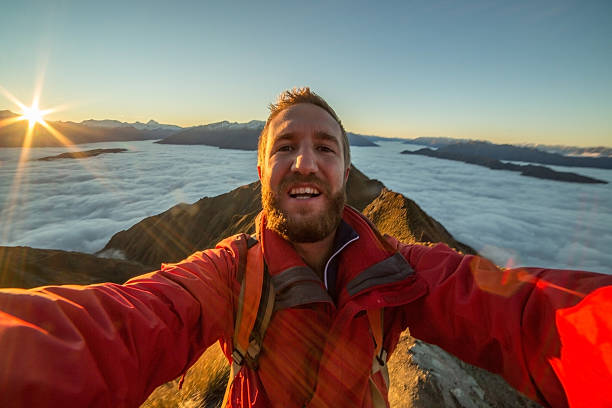 istock Selfie of hiker on mountain summit at sunset 614729094