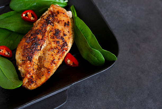 istock Chicken fillet grilled with spices and chilli. Macro filming. 614733392
