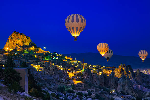 Hot Air Ballons of Cappadocia, Turkey Hot Air Ballons of Cappadocia, Turkey at night tufa photos stock pictures, royalty-free photos & images