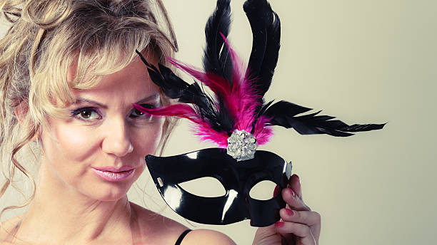 istock Woman middle aged holds carnival mask. 614734694