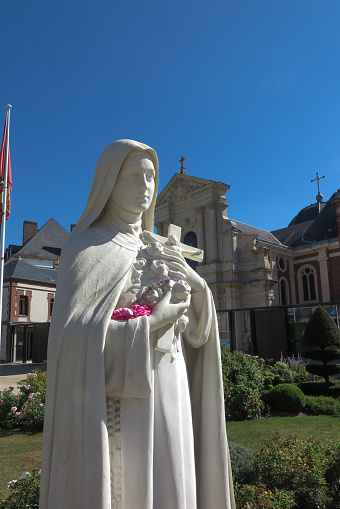 Lisieux, France - September 7, 2016: Statue of St. Therese of the Child Jesus on the square in front of the chapel of the Carmel Lisieux in France