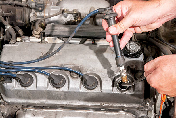 istock Mechanic tests a spark plug in an automobile 614737082