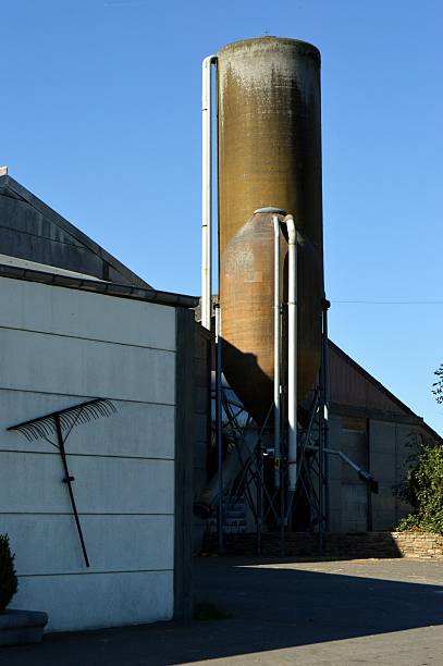 istock Grain silos in front of a barn. 614737116