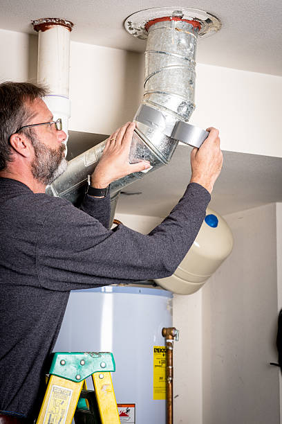 Applying tape to a hot water heater