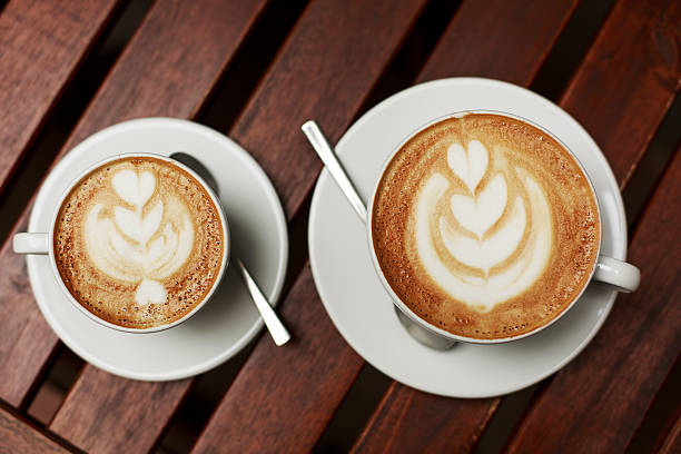 istock Two white cups of cappuccino with latte art 614737348
