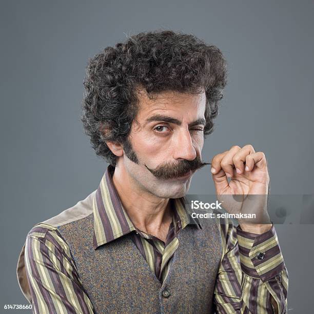 Winking Adult Man Curling Up His Handle Bar Mustache Stock Photo - Download Image Now